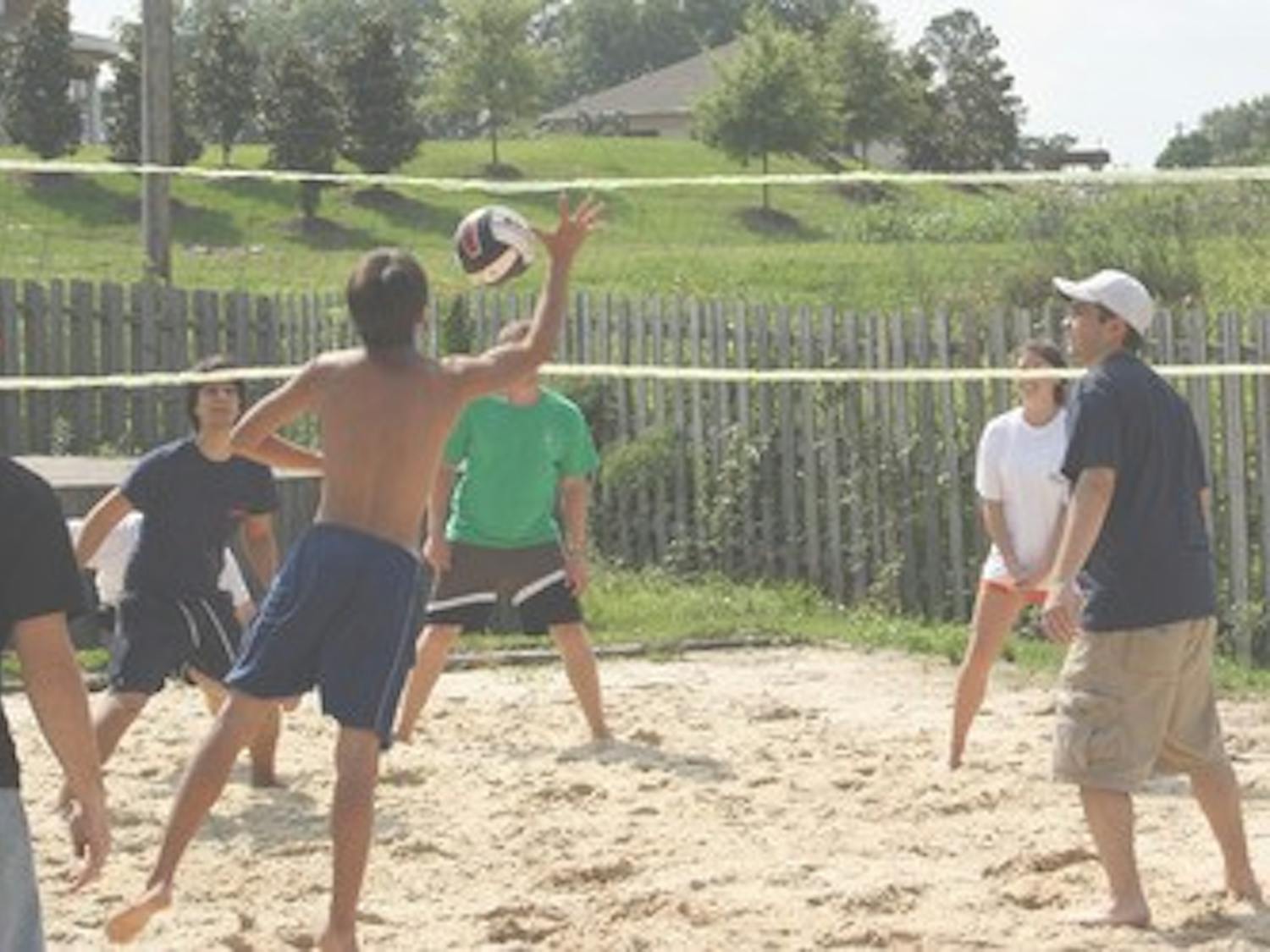 Members of the Delta Chi Fraternity and their friends take part in a friendly Saturday afternoon game of beach volleyball at their fraternity house on Lem Morrison.      Ashley Draa/Photo Editor