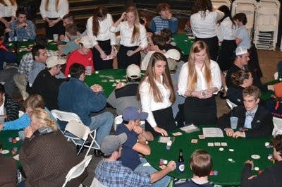 Members of Sigma Kappa and guests play a rousing game of poker complete with female dealers during the event. (Ray Maye / PHOTO EDITOR)