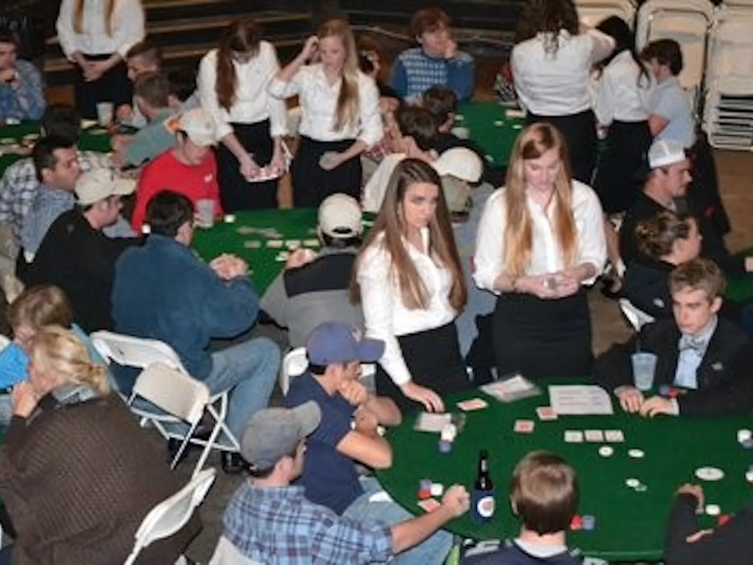 Members of Sigma Kappa and guests play a rousing game of poker complete with female dealers during the event. (Ray Maye / PHOTO EDITOR)