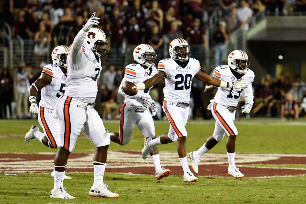Jeremiah Dinson (20) celebrates an interception with his teammates during Auburn Football vs. Mississippi State on Saturday, Oct. 6, 2018, in Starkville, Miss.