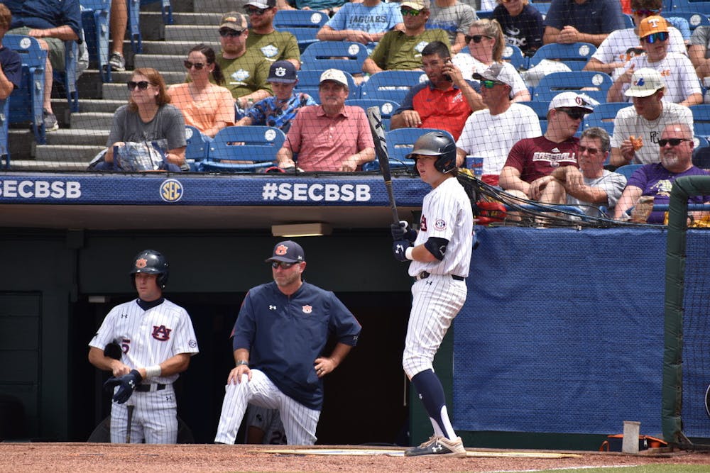 <p>Kason Howell, Butch Thompson and Brody Moore in the dugout for the SEC Tournament in Hoover.&nbsp;</p>