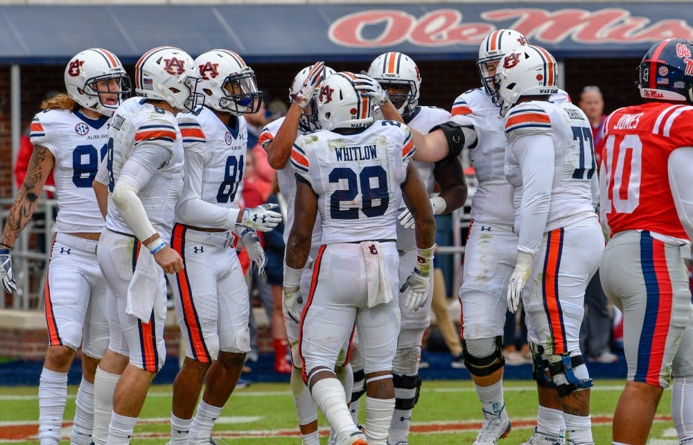 <p>Teammates approach JaTarvious Whitlow (28) after his fumble during Auburn football vs. Ole Miss on Oct. 20, 2018, in Oxford, Miss.</p>