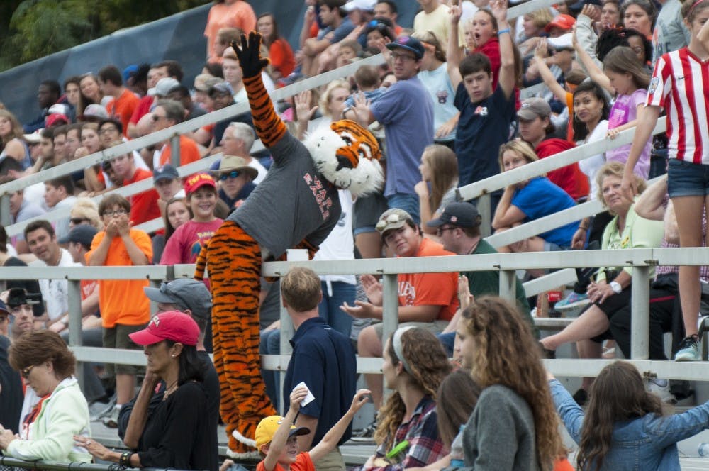 Aubie climbs over a guard rail&nbsp;during Auburn's match against Georgia at the Auburn Soccer Complex on Sunday, Oct. 25.