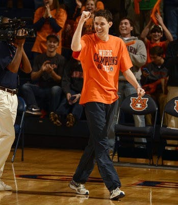 Auburn sophomore Stephen Bass celebrates winning $5000.00 in Tuition from Golden Flake at the half..Arkansas vs Auburn on Wednesday, Feb. 13. (Courtesy of Todd Van Emst / AUBURN ATHLETICS PHOTOGRAPHER)