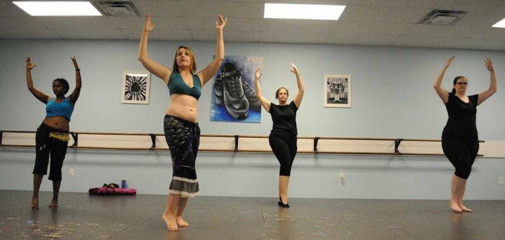 <p>Alex "Arianna" Johnson instructs a belly dance class. (Adam Sparks | Senior Photographer) </p>