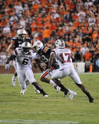 Darvin Adams rushes past USC defenders. (Christen Harned / Assistant Photo Editor)