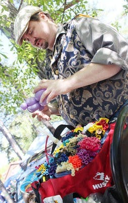 Magician Dewayne Reynolds of dRmagic makes balloon shapes at the 280 Boogie in Waverly Saturday. (Emily Adams / Photo Editor)