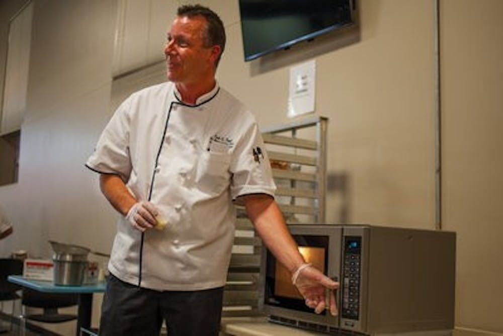 Emil Topel, senior executive chef of Chartwells, teaches students how to eat healthy and locally. (Kenny Moss | Photographer)
