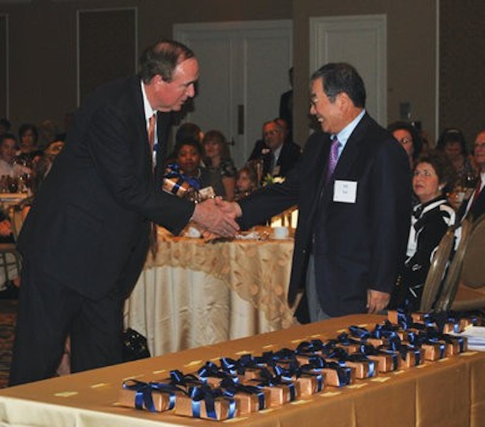 Y.Y. Lee, professor of chemical engineering, accepts his endowment from President Gogue. (Elaine Busby / Assistant Photo Editor)