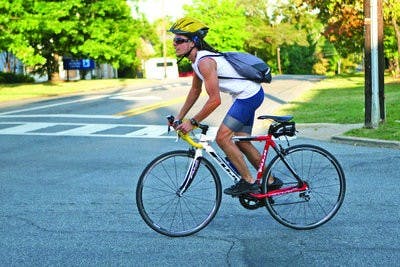 A new bike law orders cars to maintain a three-foot gap between the motorist and the bicyclist.  (Rebecca Croomes / ASSISTANT PHOTO EDITOR)