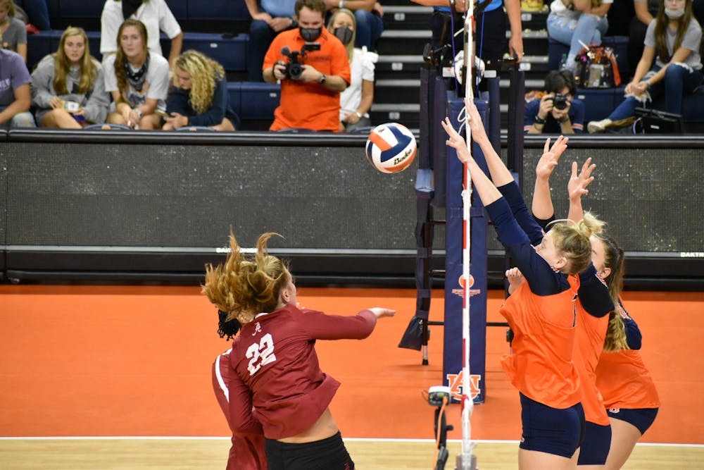 <p>Oct. 3, 2021; Auburn, AL, USA; Three Auburn defenders attempt to block an incoming spike in a match between Auburn and Alabama in the Auburn Arena.</p>