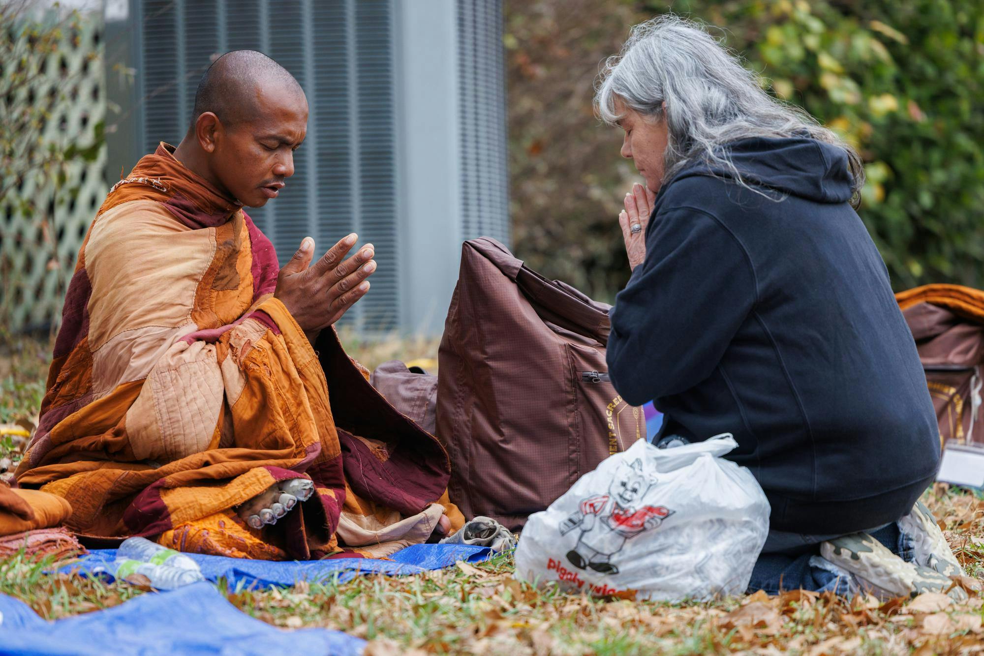 A venerable monk takes a moment to sit with a visitor and pray during the lunch stop in Cusseta, Ala. on Dec. 26, 2025.