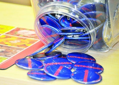 Game day buttons display slogans generated by fans, often witty comments about the opposing football team. (Katie Wittenbel / photographer)