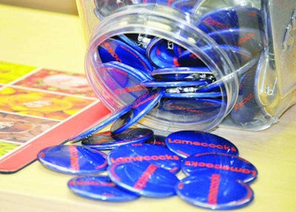 Game day buttons display slogans generated by fans, often witty comments about the opposing football team. (Katie Wittenbel / photographer)