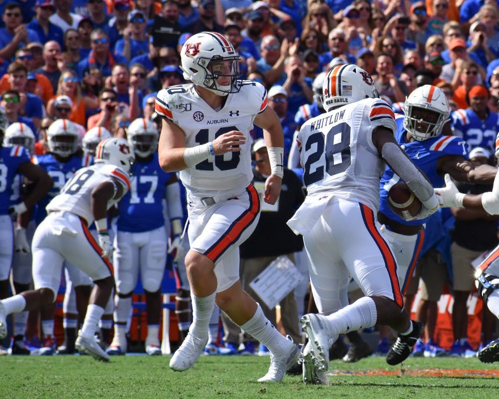 <p>Bo Nix hands the ball off to Whitlow during Auburn vs. Florida, on Saturday, Oct. 5, 2019, in Gainesville, Fl.</p>