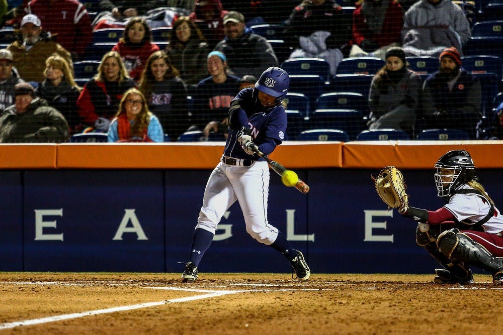 <p>Emily Carosone makes contact for her first home run of the season. (Kenny Moss | Asst. Photo Editor)</p>
