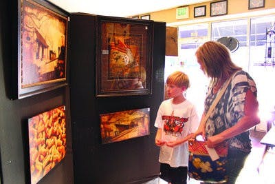 Local residents browse art gallery 478 Creative's artwork in Big Blue Bagel Friday. (Alex Sager / ASSISTANT PHOTO EDITOR)