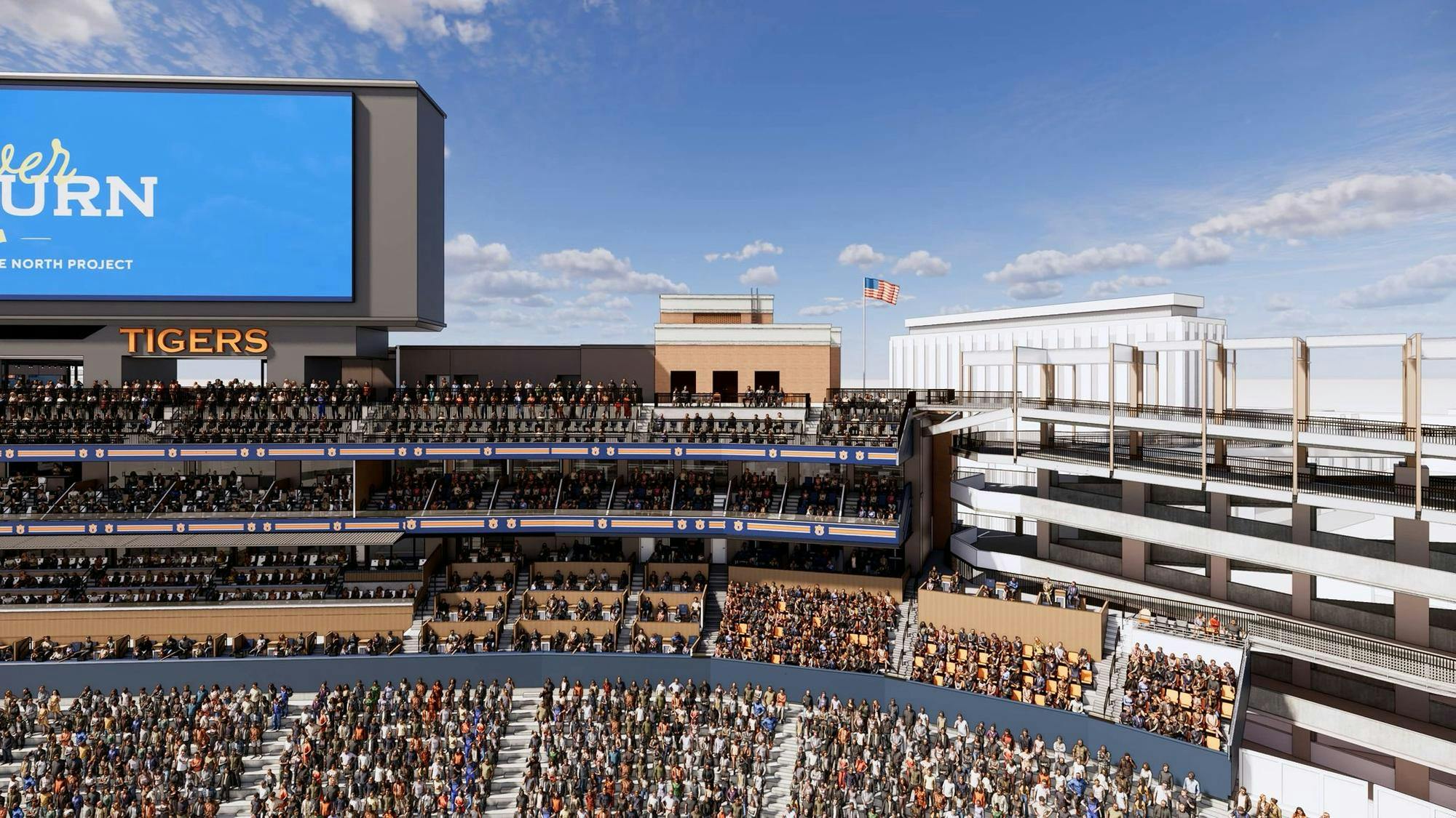 A large crowd fills a multi-tiered stadium with a prominent LED screen displaying text above a section labeled "TIGERS."