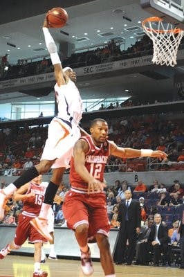 Junior forward Kenny Gabriel dunks the ball against Arkansas senior guard Marcus Britt during Saturday's 57-55  loss. (Christen Harned / Assistant Photo Editor)
