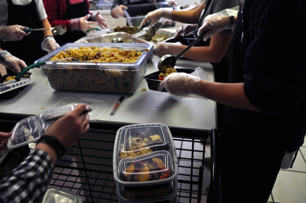 Student prepare meals at The Campus Kitchen on March 2, 2017, in Auburn, Ala. The organization repackages unserved food from dining venues into to-go meals for people in need, including students.