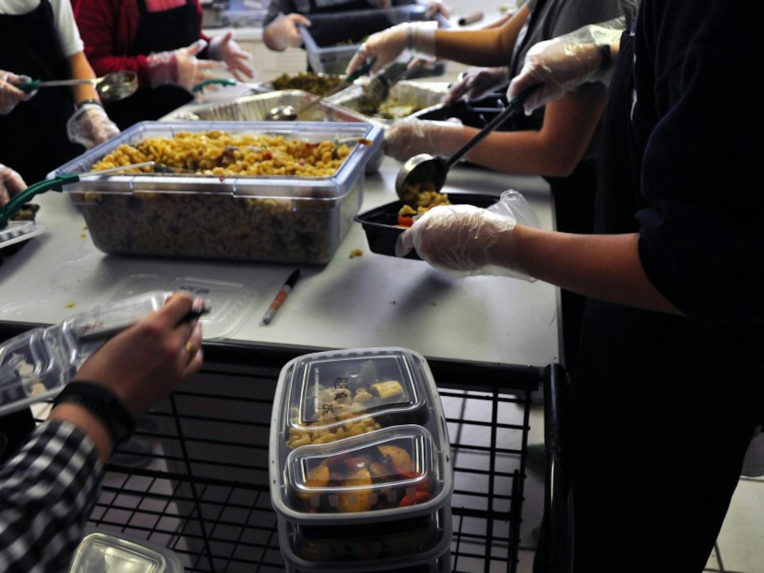 Student prepare meals at The Campus Kitchen on March 2, 2017, in Auburn, Ala. The organization repackages unserved food from dining venues into to-go meals for people in need, including students.