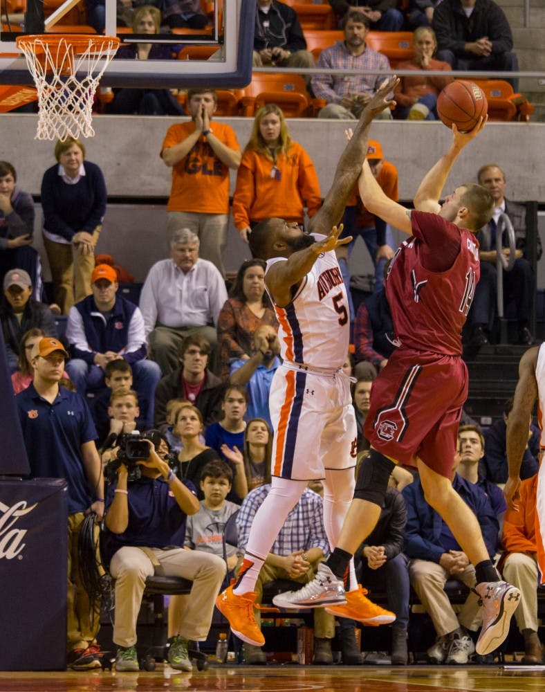 Cinmeon Bowers (5) tries to block South Carolina player Laimonas Chatkevicius’s (14) shot. South Carolina vs. Auburn at the Auburn Arena on Jan. 5, 2016.