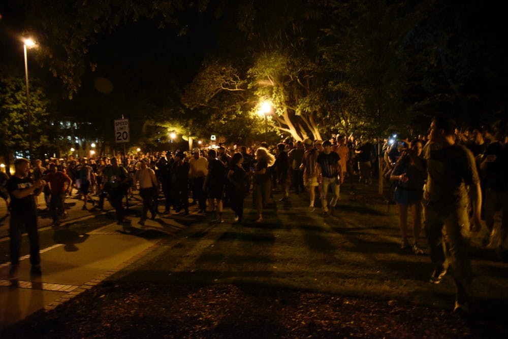 A crowd of students walk down Thach Avenue on Tuesday, April 18, 2017 in Auburn, Ala.