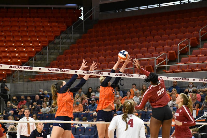 
Oct. 3, 2021; Auburn, AL, USA; Elif Yavuz (19, left) and Rebekah Rath (7, right) block an incoming spike in a match between Auburn and Alabama in the Auburn Arena.