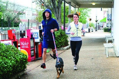Billy Callahan, senior in architecture, and Channing Broderick, senior in radio, television and film, take a jog around Toomers Corner Tuesday morning. (Rebecca Croomes / PHOTO EDITOR)