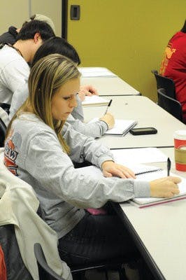 Courtney Rogers, junior in political science, takes notes in International Relations in the Middle East. Christen Harned / Assistant Photo Editor)