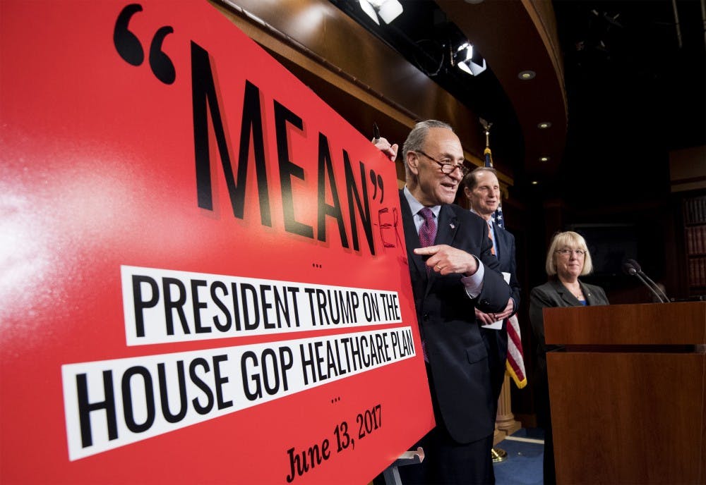 Senate Minority leader Chuck Schumer, written ''ER'' to make the poster read Meaner'' during his press conference on the Senate Republicans' health care bill with Sen. Patty Murray, and Sen. Ron Wyden, in the Capitol on Thursday, June 22, 2017. (Bill Clark/CQ Roll Call/Newscom/Zuma Press/TNS)