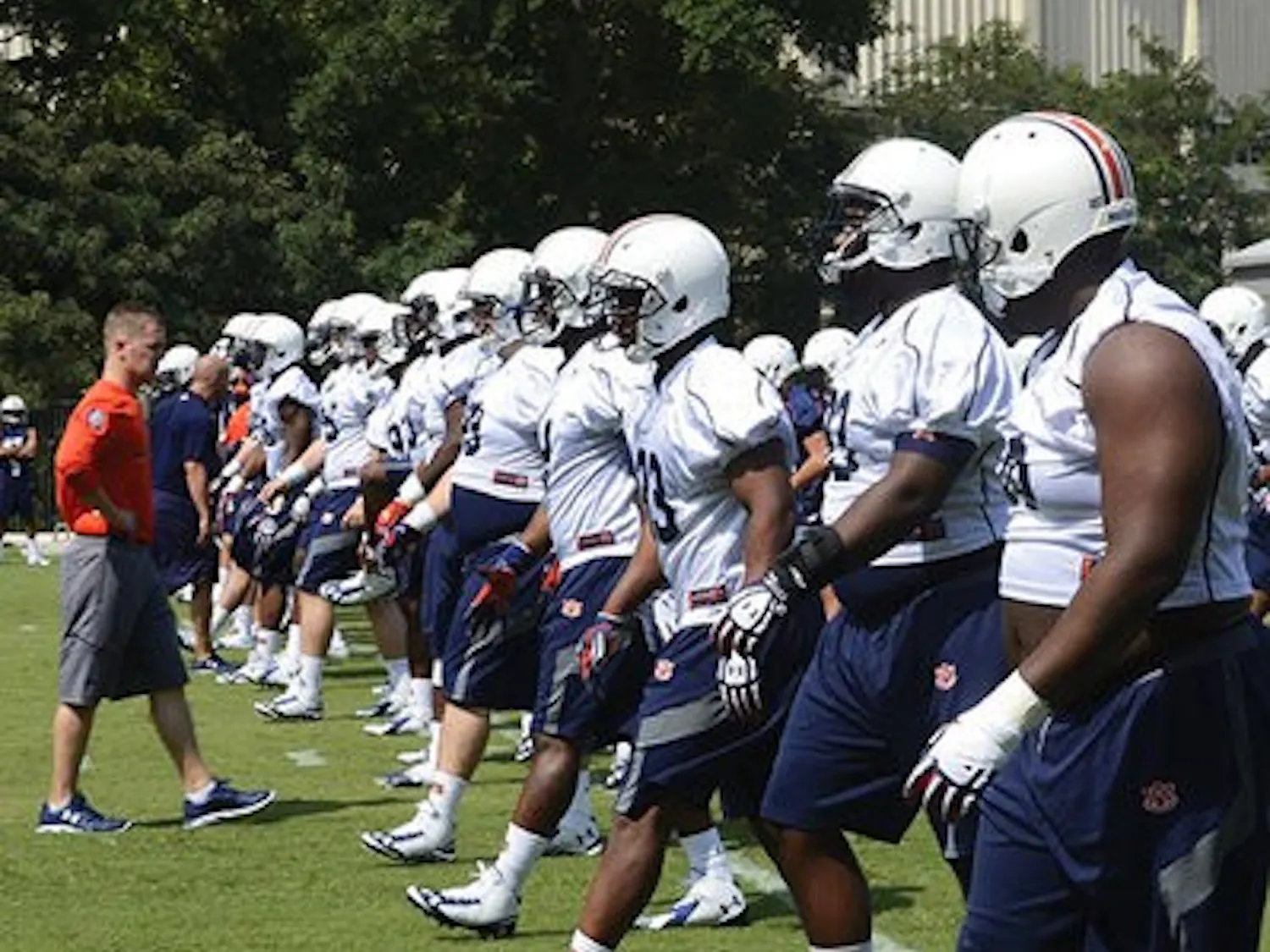 Auburn football players warm up prior to the first practice of fall camp.