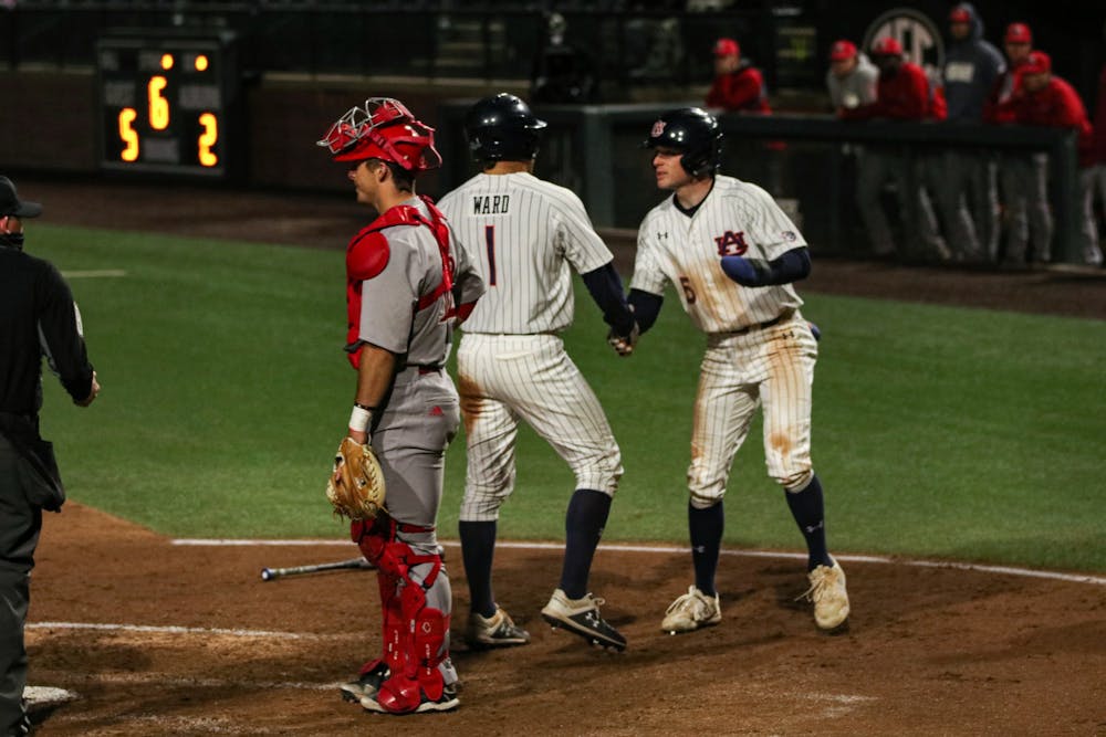 Feb 19, 2021; Auburn, AL, USA; Auburn Tigers outfielder Judd Ward (1) and Kason Howell (5) react after getting to home during the game between Auburn and Jacksonville State at Plainsman Park. Mandatory Credit: Jacob Taylor/AU Athletics