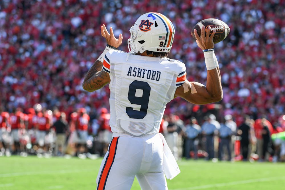 Auburn quarterback Robby Ashford (9) practices throwing passes before a game against Georgia in Sanford Stadium on Oct. 8, 2022.