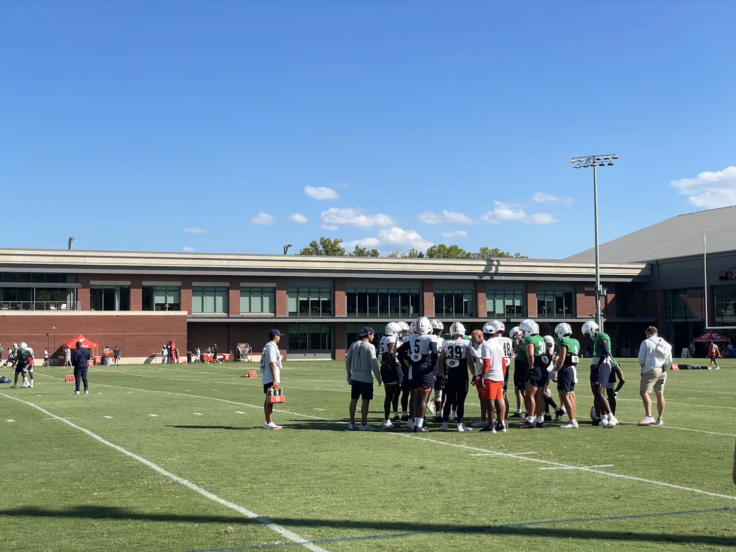 Auburn football huddles up at practice