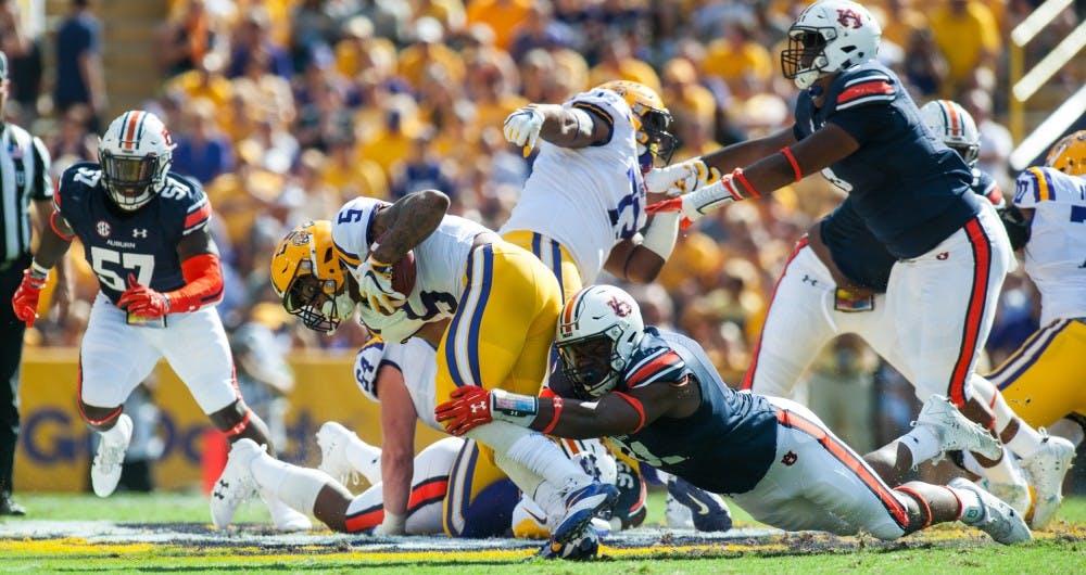 Nick Coe (91) tackles Derrius Guice (5) in the first half. Auburn vs LSU on Saturday, Oct. 14 in Baton Rouge, La.