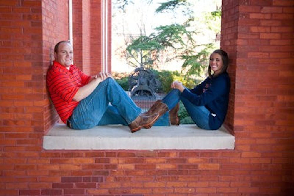 Slade Ponder and Katie Olliver sit on a ledge of Samford Hall in engagement pictures taken for the War Eagle Wedding. (Photo Courtesy of FlipFlopFoto)