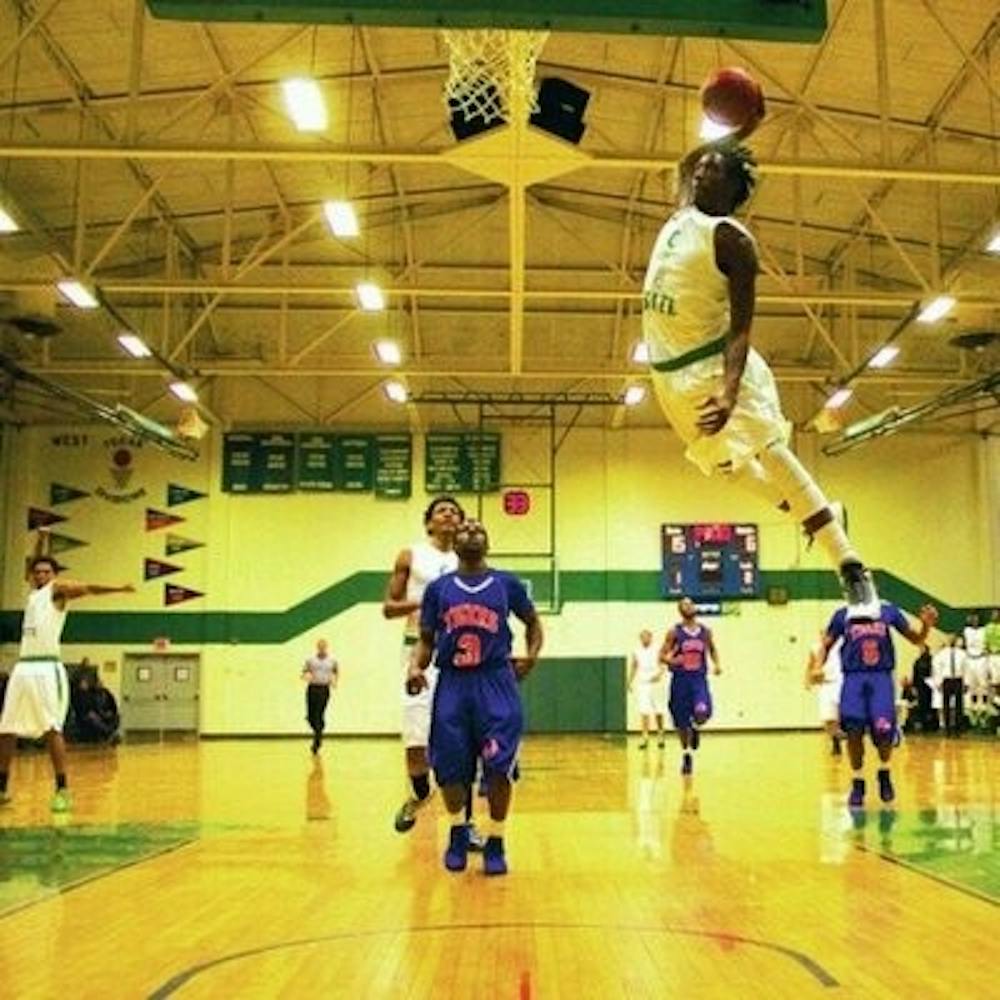 T.J. Dunans dunks in a high school game. (photo via @TJ_Grindmannn)