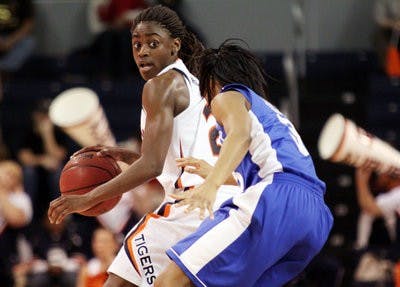Junior guard Morgan Jennings protects the ball from a Kentucky defender during the game Sunday afternoon. (Emily Adams / Photo Editor)