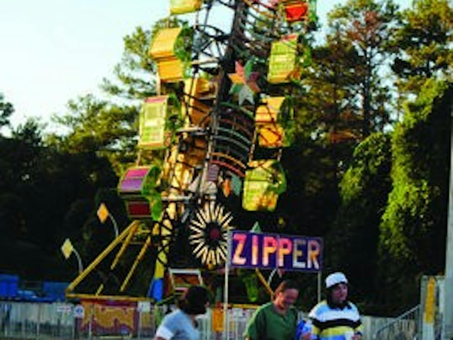 The Zipper is one of about 20 rides providing entertainment on the Midway for Lee County fair-goers. Unlimited ride passes are $20. (Maria Iampietro / PHOTO EDITOR)