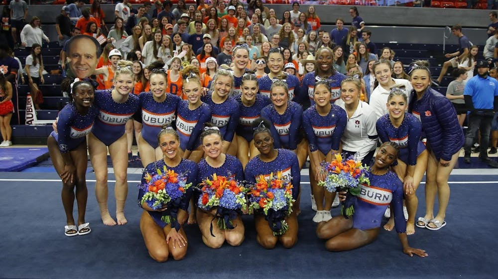 <p>Auburn celebrates as a team after a new program record score on March 4 in Neville Arena.&nbsp;</p>