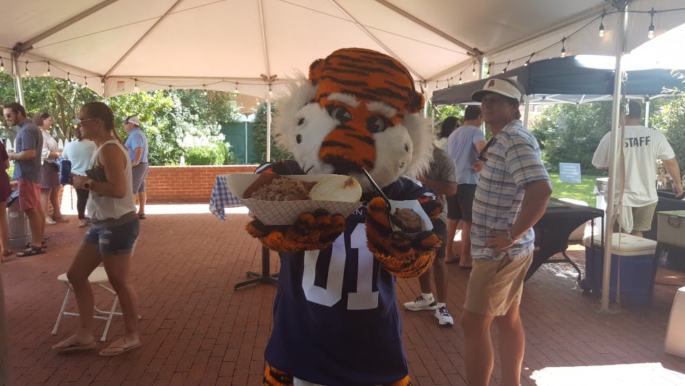 <p>Aubie holds out barbecue dishes at the Greystone Mansion's barbecue fest Sunday, Sept. 9, 2018, in Auburn, Ala.&nbsp;</p>