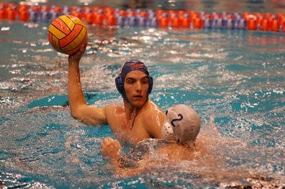 Sophomore set/driver Chris Rutledge looks to pass past freshman defender Zach Galvin in team practice Tuesday. (Charlie Timberlake / Assistant Photo Editor)