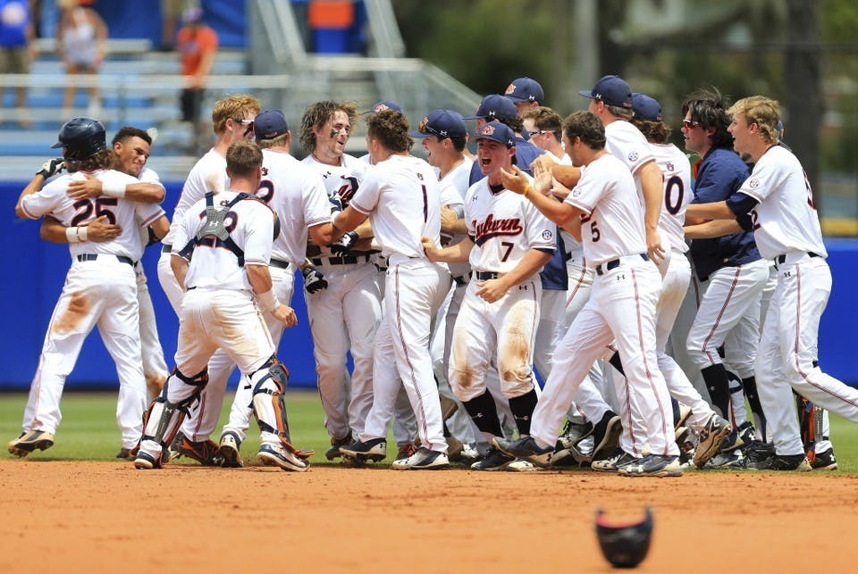 Auburn celebrates after a walk-off single by Luke Jarvis against Florida during the ninth inning of an NCAA Super Regional college baseball game Sunday, June 10, 2018, in Gainesville, Fla. (AP Photo/Matt Stamey)