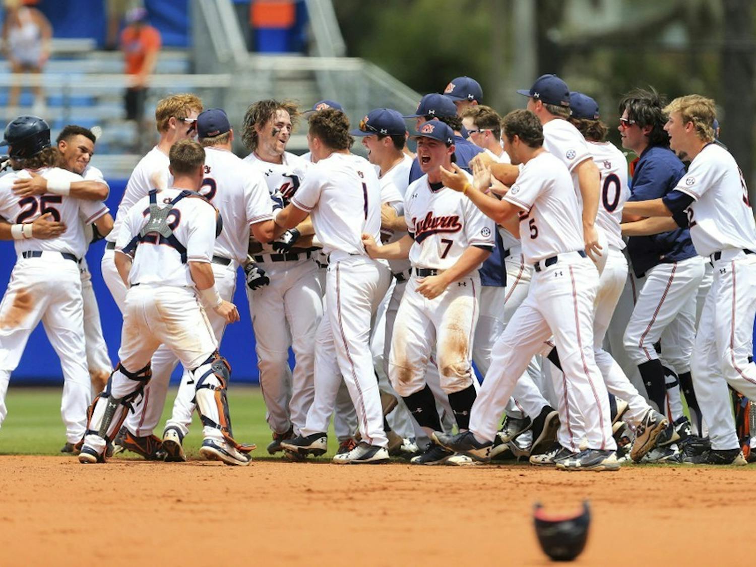 Auburn celebrates after a walk-off single by Luke Jarvis against Florida during the ninth inning of an NCAA Super Regional college baseball game Sunday, June 10, 2018, in Gainesville, Fla. (AP Photo/Matt Stamey)
