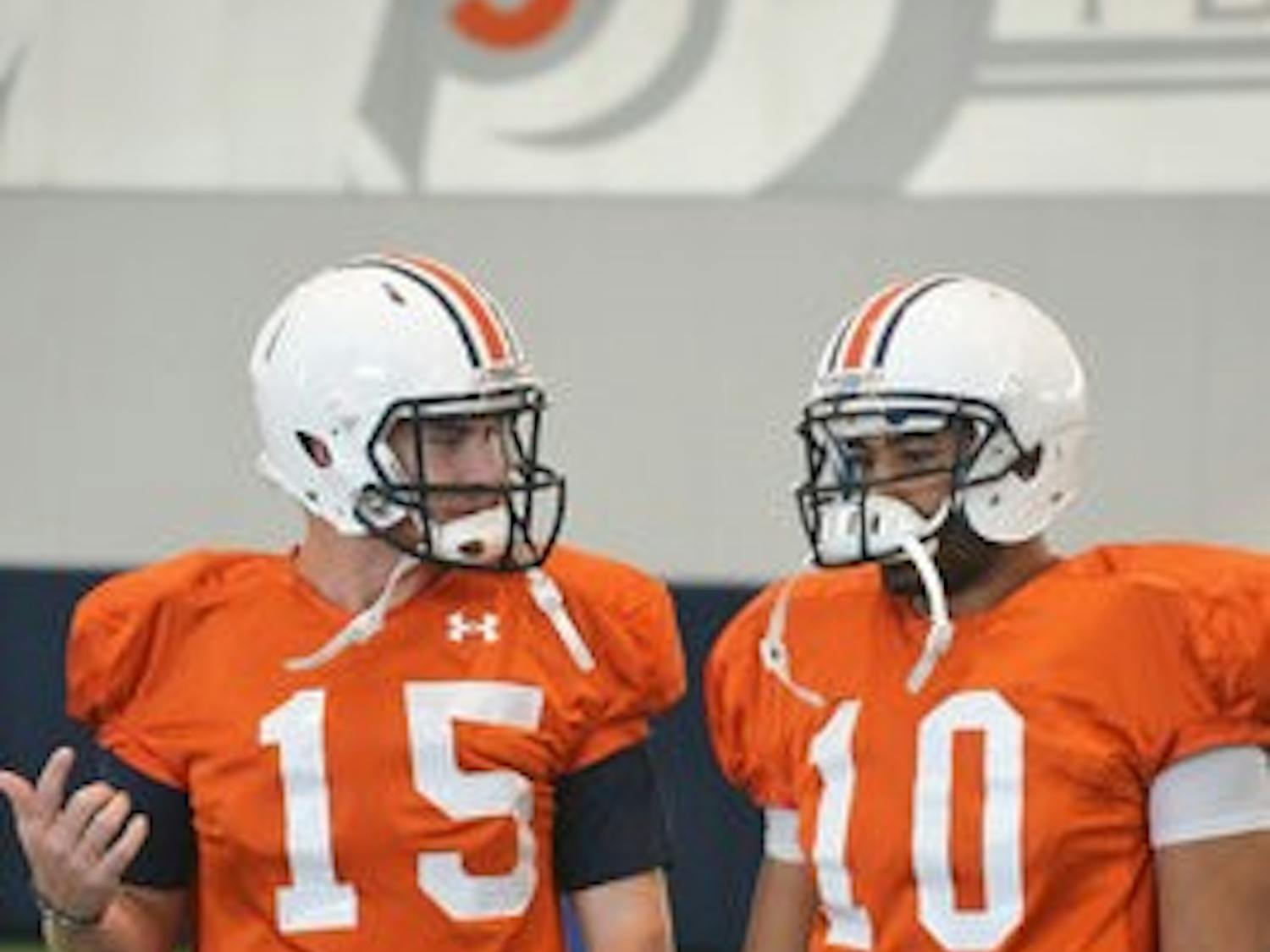 Clint Moseley (left) and Kiehl Frazier (right) talk before practice on August 3. (Danielle Lowe / PHOTO EDITOR)