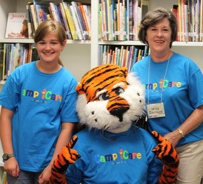 Olivia, step daughter of Women's Philanthropy Board Member and Former WPB President Darlene Woodall, spends time with Aubie at Camp iCare. (Courtesy of Samantha Allbrook)