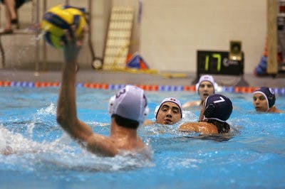 An alumnus prepares to dry pass during the Auburn-AU Alumni game at last weekend's water polo tournament. (Rebekah Weaver / Assistant Photo Editor)
