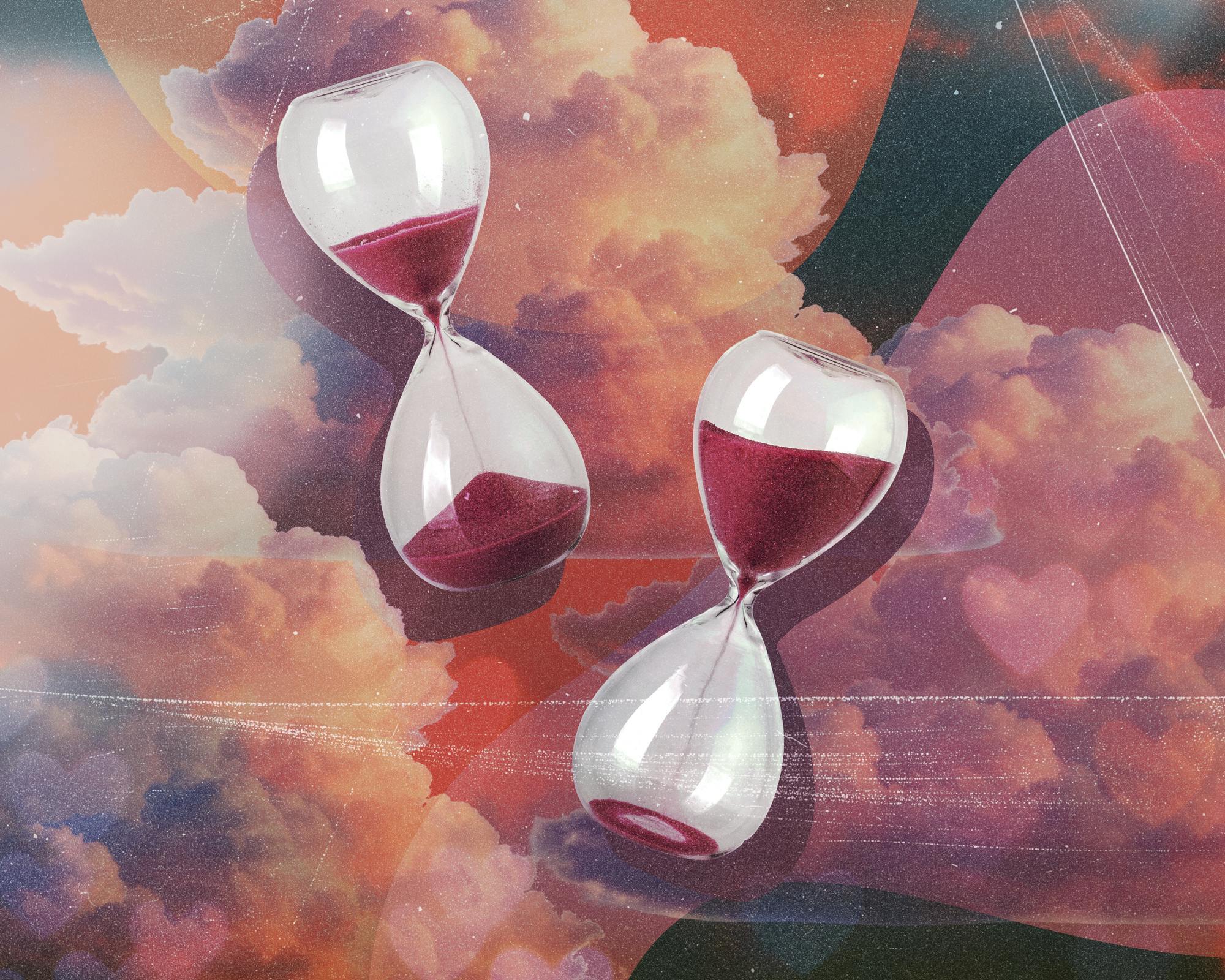 Two glass hourglasses filled with red sand are positioned on a textured background of soft, colorful clouds.