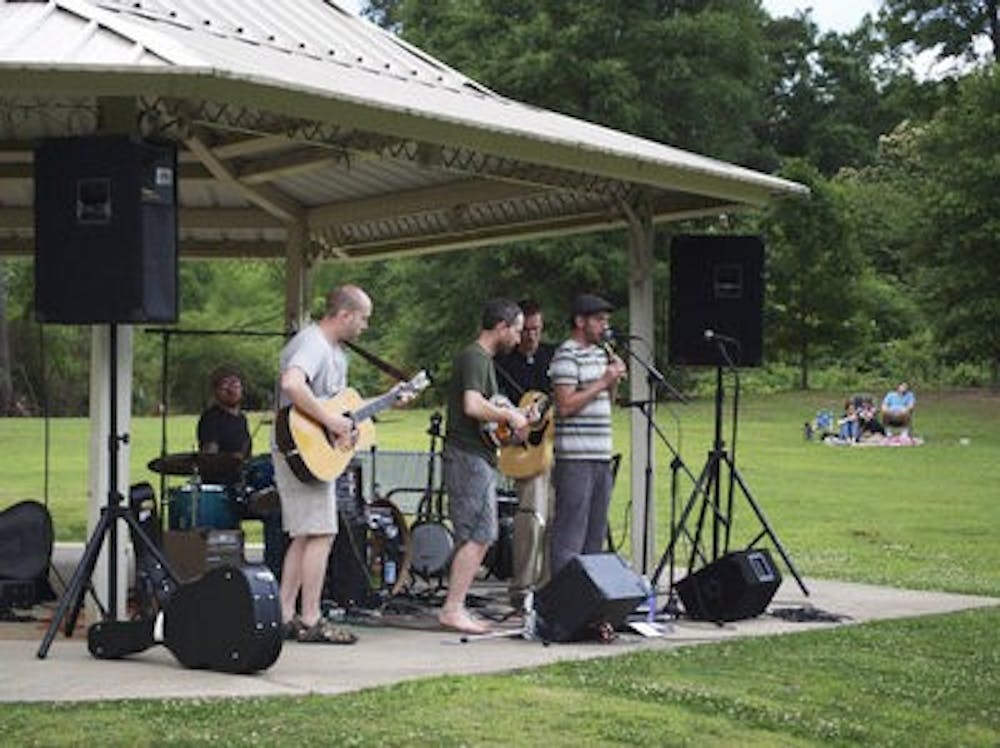 Ryan Vanderberry, on guitar; Geoffrey Stockinger, on mandolin; Adam Powell, lead vocals; Drew Martin, on guitar; and Britt Powell, drummer, played a set at a park (Reese Counts | Intrigue Writer)